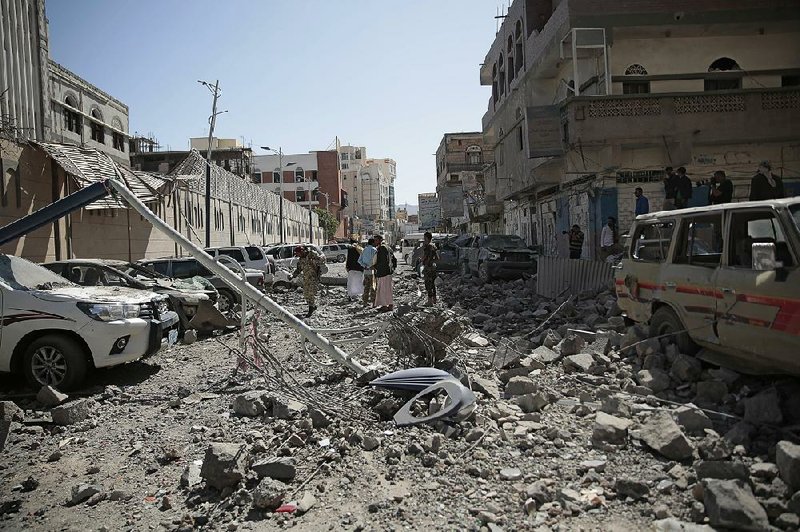 A lamppost lies amid the rubble after deadly airstrikes in and near the presidential compound Monday in Sanaa, Yemen. 