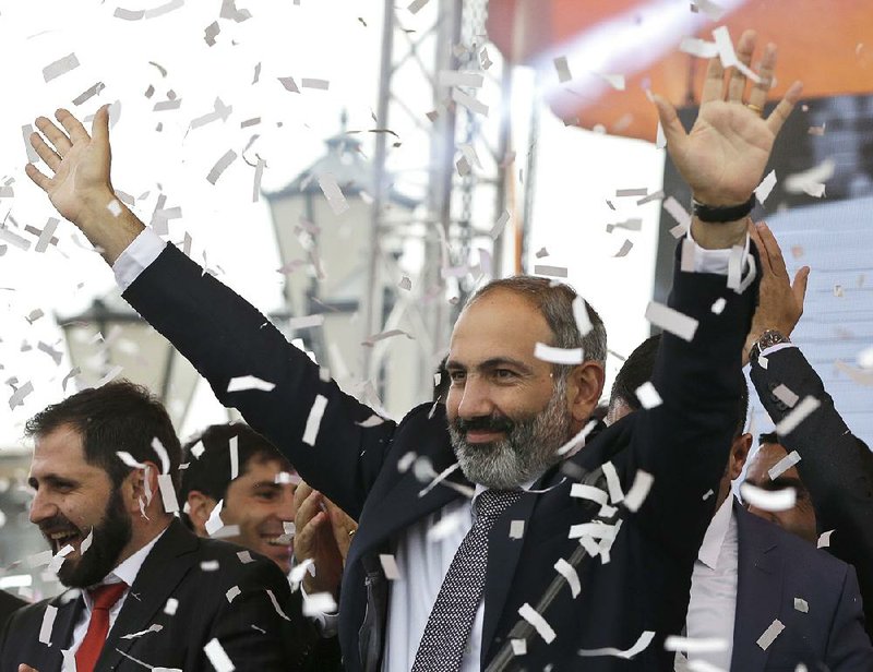 Newly elected prime minister of Armenia, Nikol Pashinian, greets supporters Tuesday in Yerevan’s Republic Square. 