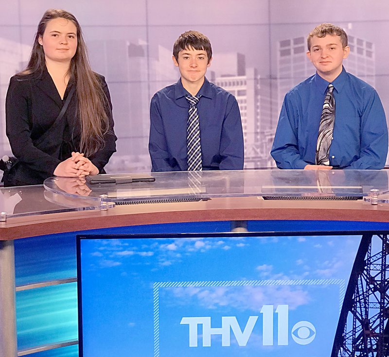 JONI WILSON Ashley Guess, Jacob Truman and Jonathan Brinkley sit at the Cannel 11 newsdesk in Little Rock. The Gentry students took second place in a social media campaign to promote career and technical education on April 17.