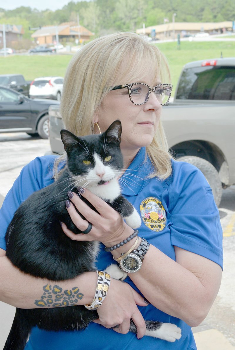 Keith Bryant/The Weekly Vista Dispatcher Stacey Wigginton holds the police department&#x2019;s cat, Petey.