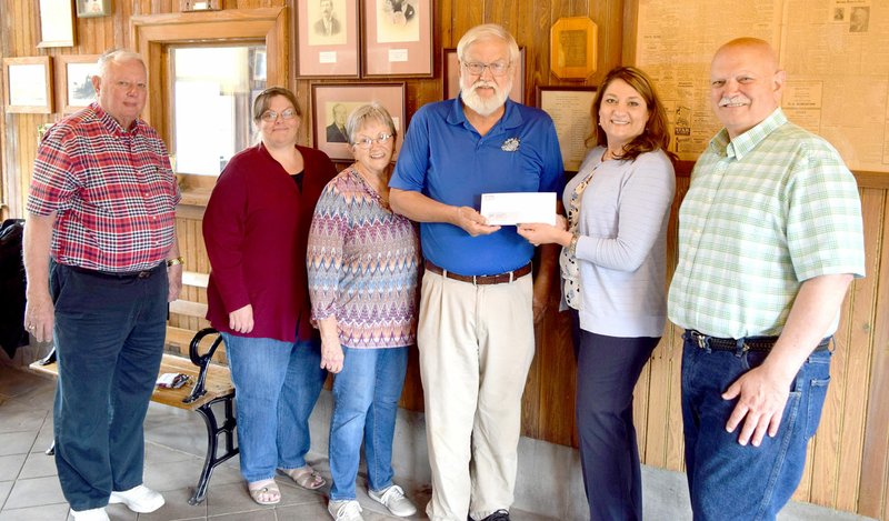 Westside Eagle Observer/SUBMITTED Members of the Decatur Historical Commission gathered in the train master's office at the Decatur Depot May 5 to accept a check from the Benton County Historical Commission for the renovation of the depot, shed and log cabin in downtown Decatur. On hand for the ceremony was Lynval Abercrombie (left), Jeanelle Cox, Linda Martin, Mike Eckels (committee chair), Cassie Elliott (Decatur grant writer) and Mayor Bob Tharp.