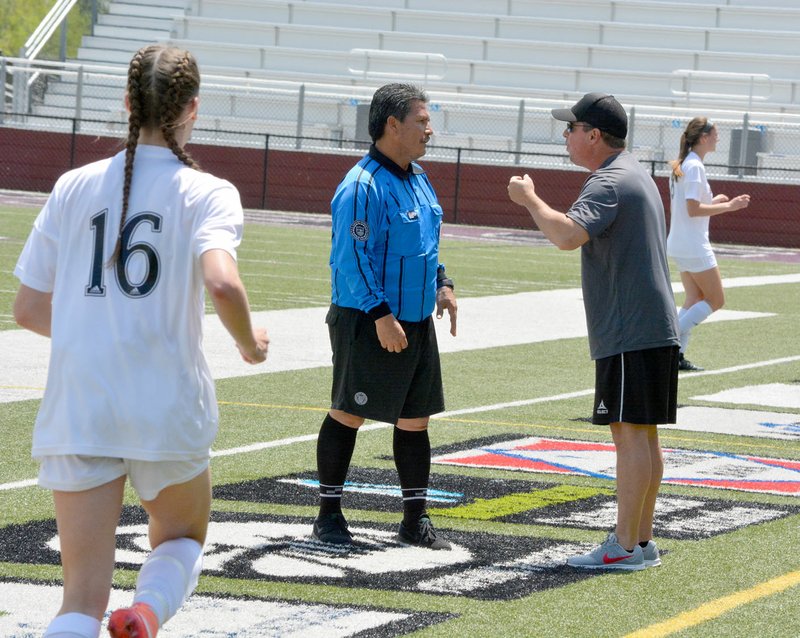 Graham Thomas/Herald-Leader Siloam Springs head coach Brent Crenshaw argues a call with the center official Jose Sosa during Saturday's 6A-West Conference girls championship game. Siloam Springs defeated Benton 5-2.