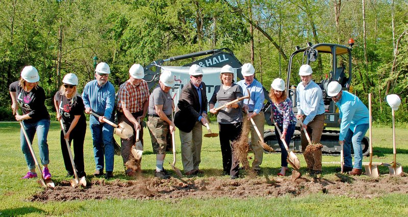 Janelle Jessen/Herald-Leader Officials from Simmons Foods, the city and Tailwaggers broke ground on a new dog park on the west end of Bob Henry Park on Monday morning.