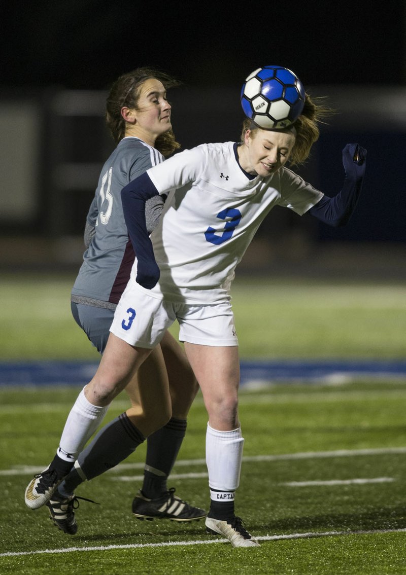 Skylurr Patrick (3) of Rogers wins a header over Brooklyn Buckminster of Siloam Springs on March 6 at Whitey Smith Stadium in Rogers.