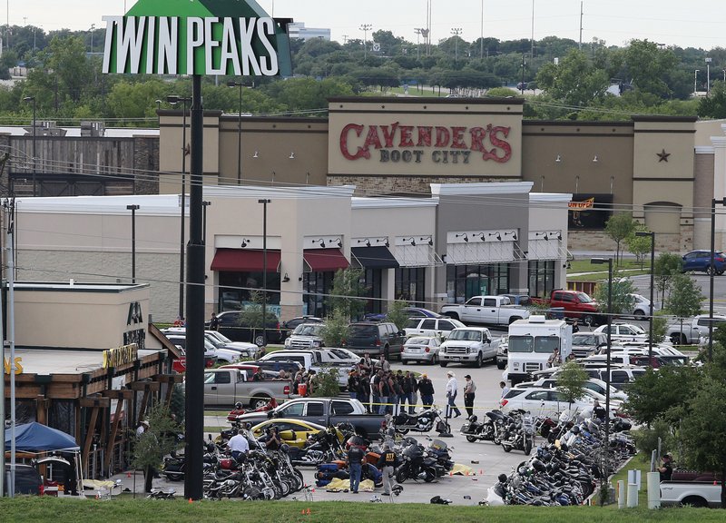 In this May 17, 2015 file photo, authorities investigate a shooting in the parking lot of Twin Peaks restaurant in Waco, Texas. Prosecutors have dismissed another 42 cases relating to the 2015 shooting in Waco involving rival biker gangs that left nine dead and 20 others injured. McLennan County prosecutors said Tuesday, May 8, 2018, they're dismissing the cases while focusing on "more culpable" defendants. 