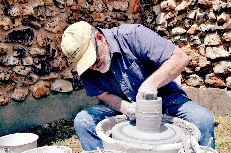 RACHEL DICKERSON/MCDONALD COUNTY PRESS Dennis Bergen of Anderson works at a pottery wheel at the New Bethel School Preservation Association's Old Time Craft Festival on Saturday.