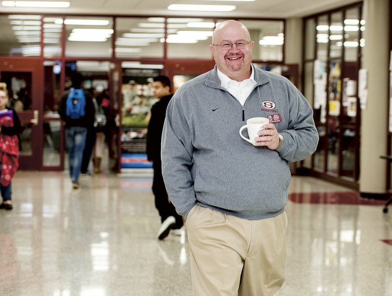 File photo/NWA Democrat-Gazette/ANTHONY REYES Pete Joenks, Springdale High School principal, walks the halls in December 2016 at the school. Joenks will be leaving the district to become an assistance superintendent for Prairie Grove's school district.