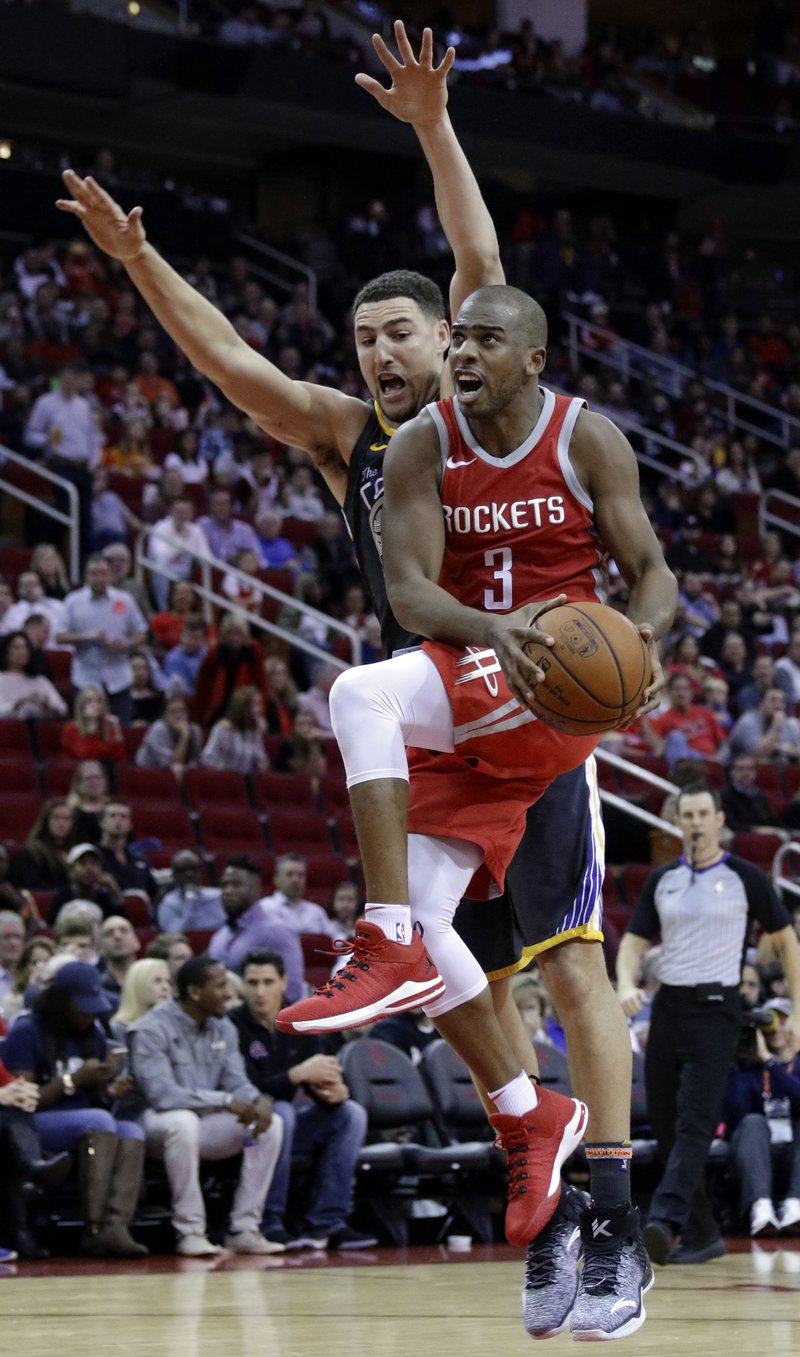 FILE - In this Jan. 20, 2018, file photo, Houston Rockets guard Chris Paul (3) shoots in front of Golden State Warriors guard Klay Thompson (11) during the second half of an NBA basketball game, in Houston.  (AP Photo/Michael Wyke, File)