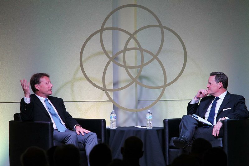 Particle physicist Michael Strauss (left) talks with the Rev. Steven Smith, senior pastor of Immanuel Baptist Church in Little Rock, at the third City Center Conversations: Conversations About God, Life and Faith in the City, on Tuesday. 
