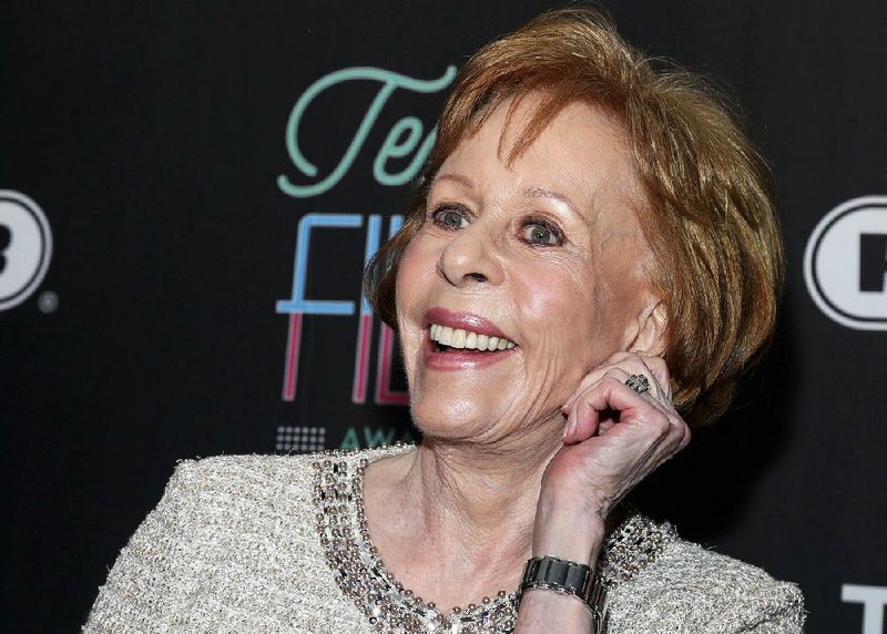 In this March 10, 2016 file photo, Texas Film Hall of Fame honoree Carol Burnett tugs on her ear at the 2016 Texas Film Awards at Austin Studios in Austin, Texas. 