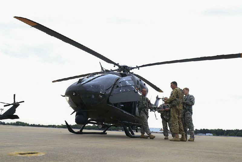 Arkansas Democrat-Gazette/STATON BREIDENTHAL --5/10/18-- Crew members (left to right) CW2 Richard Rogers, Sgt. Steve Guinn, CW5 Jeff Apke and Sgt. Jake Brandt go through their pre-flight briefing Thursday morning at Camp Robinson before flying their Arkansas National Guard UH-72 Lakota helicopter to New Mexico for a border patrol mission. The guard is sending 10 soldiers and two helicopters to assist the Border Patrol in reconnaissance operations. 