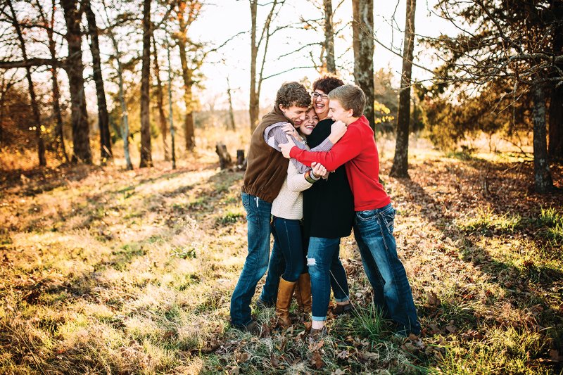 Kerry Pitt of Searcy and her 18-year-old triplets, Drew, from left, AneElise and Wade, share a group hug during a photo shoot. “I always took them individually to places to have special time,” Pitt said, adding that as a mother, she has “no regrets.