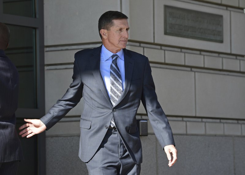 FILE - In this Dec. 1, 2017 file photo, former national security adviser Michael Flynn leaves federal court in Washington. Flynn has been campaigning to support Republican candidates, as he awaits sentencing after pleading guilty to lying to the FBI. In May 2018, Flynn endorsed Montana Republican Senate candidate Troy Downing in a video message, then followed up with a radio interview. In March, he made a personal appearance in California with Republican Omar Navarro in his primary bid for the chance to run against 14-term Democratic U.S. Rep. Maxine Waters. (AP Photo/Susan Walsh, File)