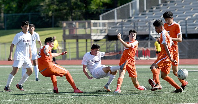 Bud Sullins/Special to Siloam Sunday Siloam Springs midfielder Julio Maldanado, middle, scores the the game-winning goal in the second half for Siloam Springs on Friday against Little Rock Hall.