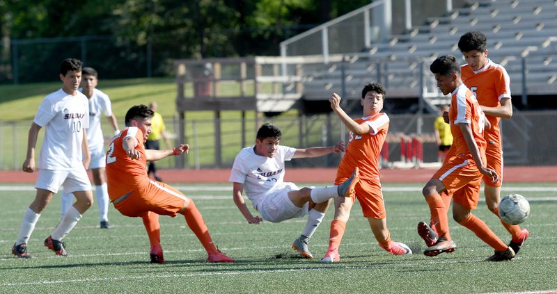 Bud Sullins/Special to Siloam Sunday Siloam Springs midfielder Julio Maldanado, middle, scores the the game-winning goal in the second half for Siloam Springs on Friday against Little Rock Hall.