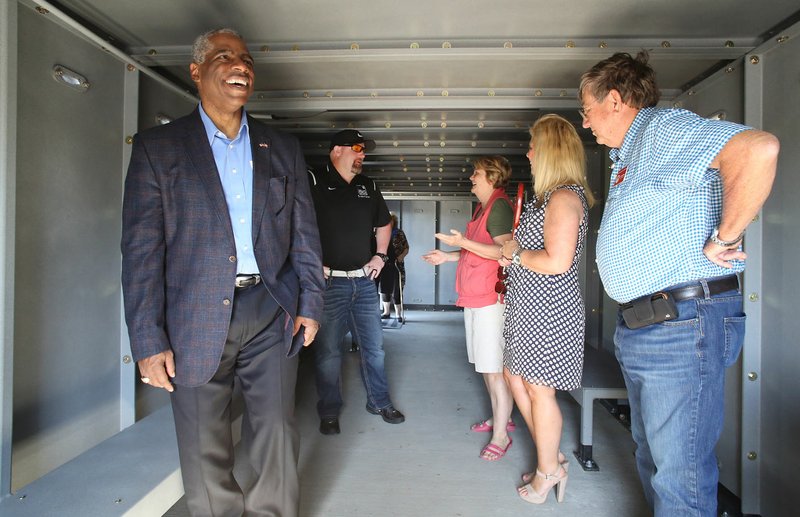 Washington County Judge Joseph Wood (from left), Josh King, with Atlas Safe Room, Marilyn La Combe, of Evansville, and county officials Sharon Lloyd, grants administrator, and Carl Gates, chief of staff, tour Friday the new storm shelter next to the Evansville Community Center. The room was built with help from the Northwest Arkansas Economic Development District. 
