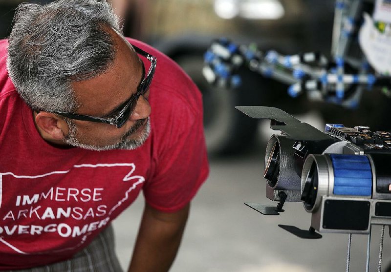Wade Radke of North Little Rock takes a look at a “Johnny 5” robot head Saturday during the fourth annual Mini Maker Faire at the North Shore Riverwalk in North Little Rock. Johnny 5 was a character in the 1986 film Short Circuit.  