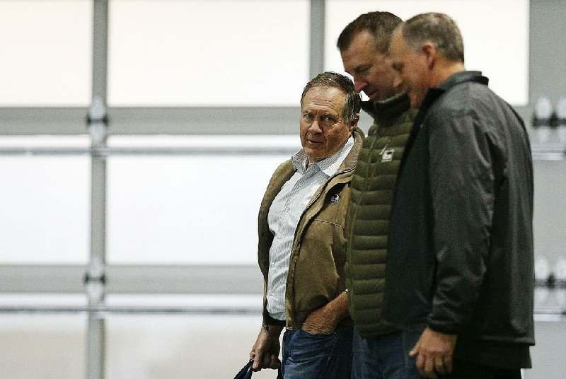 New England Patriots Coach Bill Belichick (left) and former Arkansas Coach Bret Bielema (center) walk the field during Alabama’s Pro Day on March 7 in Tuscaloosa, Ala. According to ESPN’s Field Yates, Bielema continues to work for the Patriots organization and is expected to be involved in coaching duties as well. 