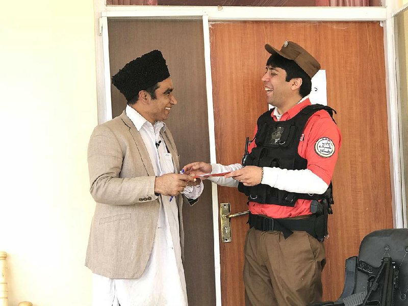 Mohammad Ibrahim Abed (left) and Seyar Matin act out a skit making fun of an Afghan parliament member during a recent episode of Laughter Network at the show’s studio in Kabul.  