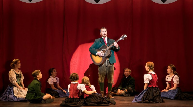 Mike McLean (center) portrays Captain Georg von Trapp in “The Sound of Music.” The current touring production is the original Broadway version, which debuted in 1959 and differs slightly from the Julie Andrews film. “[It’s] a story everybody knows, and they’ve seen the movie 100,000 times,” McLean says. “If you come see our show, you’re going to see something new in the show. It is slightly different. But don’t worry, we still escape the Nazis.” 
