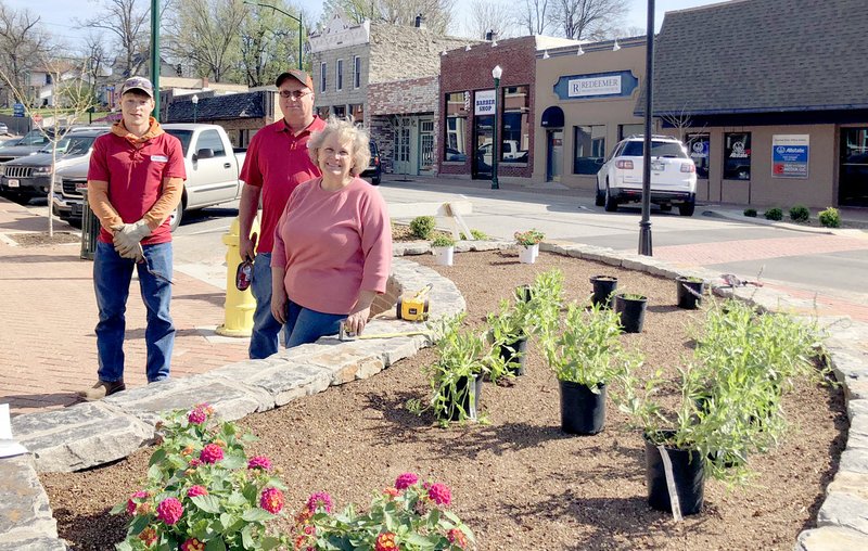 Abby Trinidad/Special to the Herald-Leader Dawn Denton, right, recently planted flowers in the new downtown bump-outs with the help of city employees.