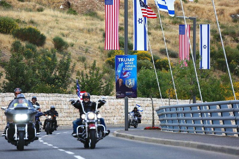 Members of the Samson Riders, an Israeli motorcycle club, cruise Sunday on a road leading to the new U.S. Embassy in Jerusalem after riding from the older embassy in Tel Aviv. The new embassy is to formally open today. 
