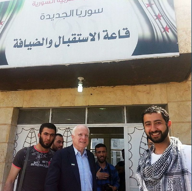 Mouaz Moustafa (right), the executive director of the Syrian Emergency Task Force, is shown with Sen. John McCain (center) as they visit Syrian rebels in May 2013. Moustafa says his “letters of hope” effort was meant to show the people of war-torn Syria “that they have not been forgotten.” 
