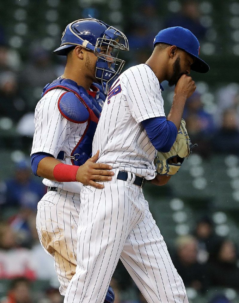 Chicago Cubs catcher Willson Contreras talks with relief pitcher Carl Edwards Jr. during the eighth inning of Saturday’s game against the Chicago White Sox. Edwards had a rare bad day, prompting a Twitter user to suggest he be demoted to Class AAA Iowa. 