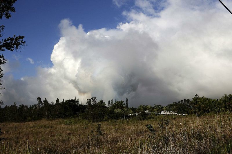 Volcanic gases rise Sunday from the lava fissure discovered near Pahoa, Hawaii. 
