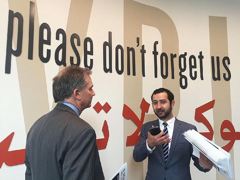 In this file photo Mouaz Moustafa (right), executive director of the Syrian Emergency Task Force, visits with U.S. Rep. French Hill, R-Ark., in April at the U.S. Holocaust Memorial Museum in Washington. 
