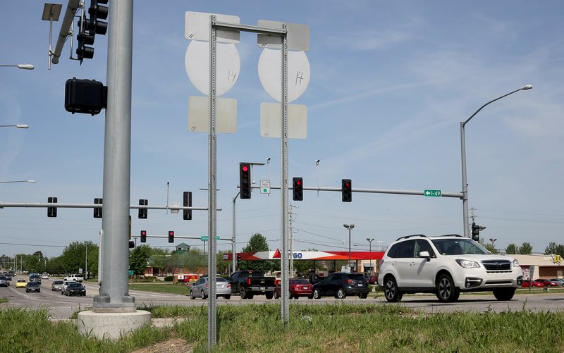 Traffic travels east Tuesday on Wedington Avenue at the Interstate 49 interchange. The Arkansas Department of Transportation has asked Fayetteville to relocate water and sewer lines that conflict with proposed improvements at the interchange. Costs to relocate the lines are estimated at $3.6 million. 