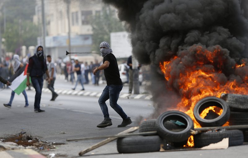 Palestinians clash with Israeli troops following a protest against the U.S. decision to relocate it's Israeli embassy to Jerusalem, in the West Bank city of Bethlehem, Monday, May 14, 2018. Several thousand people gathered in the center of Ramallah, while hundreds marched to the Qalandiya crossing on the outskirts of Jerusalem, where protesters threw stones at Israeli troops with their anger fueled by the embassy opening. (AP Photo/Majdi Mohammed)

