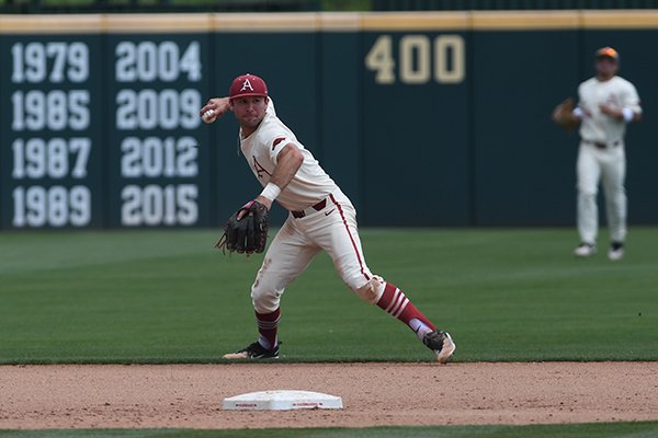 Arkansas shortstop Jack Kenley makes a throw to first base during Arkansas' 6-3 win over Texas A&M Sunday May 13, 2018 at Baum Stadium in Fayetteville.