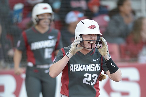 Arkansas Hannah McEwen celebrates after scoring a run Friday, March 30, 2018, during the fourth inning against Mississippi State at Bogle Park in Fayetteville.