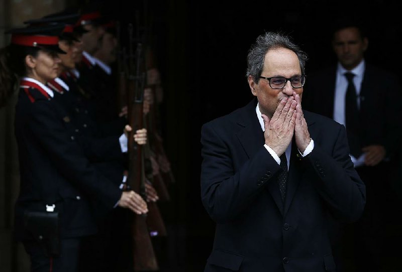 Quim Torra, the newly appointed chief of Spain’s Catalonia region, leaves the parliament building Monday in Barcelona. 