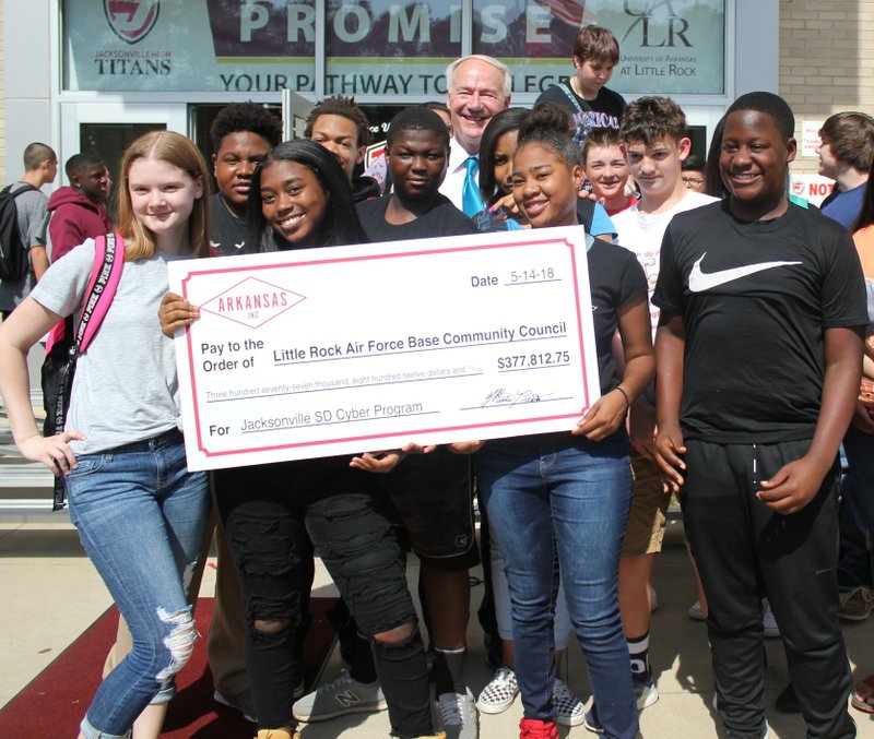 Arkansas Gov. Asa Hutchinson is shown on May 14, 2018, with students from Jacksonville High School, which received a Military Affairs Grant Award to develop a cyber security curriculum on campus in partnership with the Little Rock Air Force Base.