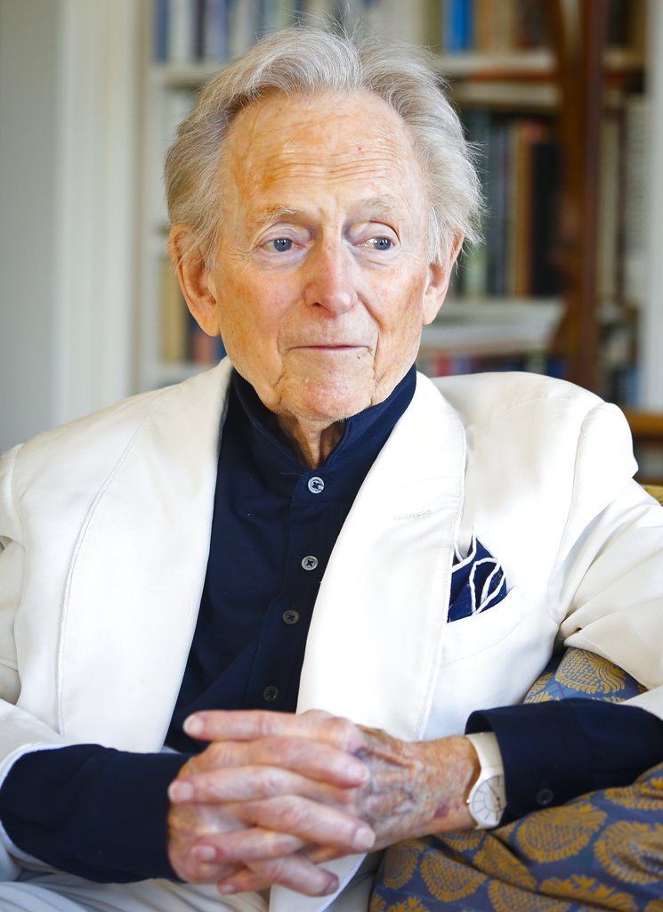 CORRECTS AGE TO 88 - FILE - In this July 26, 2016 file photo, American author and journalist Tom Wolfe, Jr. appears in his living room during an interview about his latest book, "The Kingdom of Speech," in New York. Wolfe died at a New York City hospital. He was 88. Additional details were not immediately available. (AP Photo/Bebeto Matthews, File)