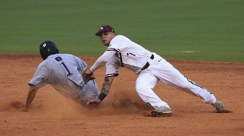 Central Arkansas base runner T.J. Black (1) slides past the tag attempt of UALR shortstop Matt Merino to steal second base during Tuesday night’s game at Dickey-Stephens Park in North Little Rock. UCA won 6-4. 