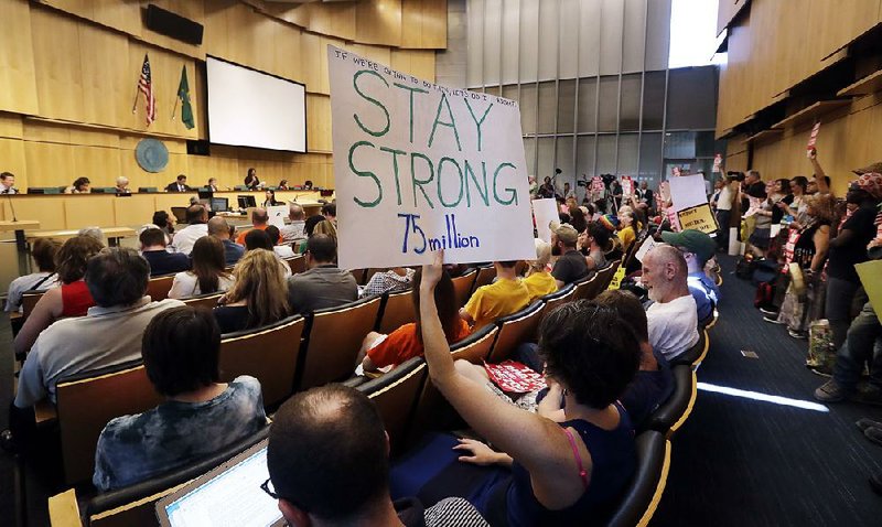 People pack the room Monday for the Seattle City Council’s vote on a per-employee tax on large businesses to help the city’s homeless.  
