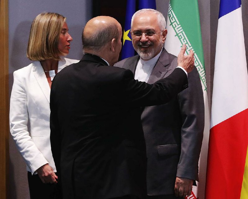 European Union foreign-policy chief Federica Mogherini and French Foreign Minister Jean-Yves Le Drian (back to camera) meet Tuesday with Iranian Foreign Minister Mohammad Javad Zarif in Brussels.  