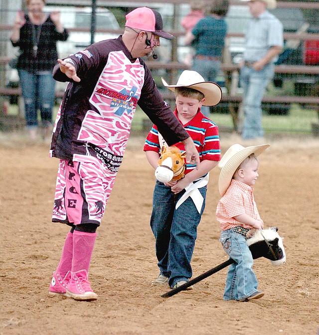 MARK HUMPHREY ENTERPRISE-LEADER Jerry Casey, also known as "The Sarge," rodeo clown for the 64th annual Lincoln Rodeo in 2017 directs traffic during the stick-horse grand entry. Ethan Parker, 2017 Lincoln Riding Club Lil' Mister, was about to have a runaway with his stick-horse mount and had to be cautioned not to run over a little cowboy bringing up the rear of the grand entry. The 65th annual Lincoln Rodeo has been rescheduled for Aug. 9-11, 2018.
