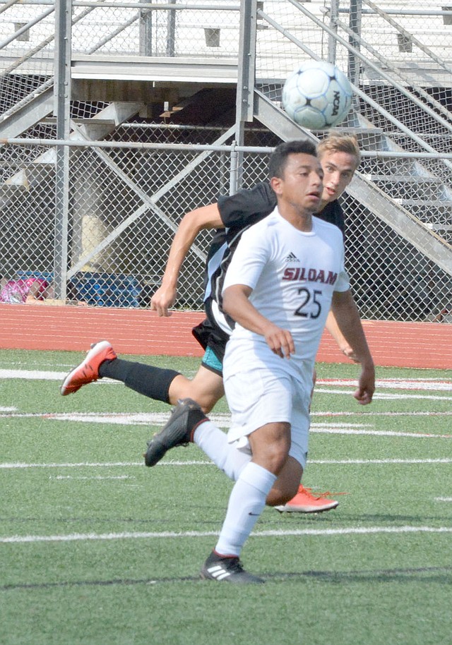 Graham Thomas/Herald-Leader Siloam Springs senior Irvin Rios plays the ball forward against Benton during the Class 6A semifinals on Saturday in Russellville.