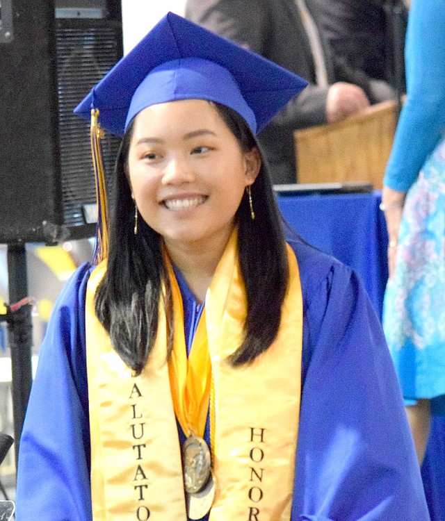 Westside Eagle Observer/MIKE ECKELS Mailee Xiong walks down the exit ramp after receiving her diploma at the end of the Decatur High School Class of 2018 graduation ceremony at Peterson Gym May 13.