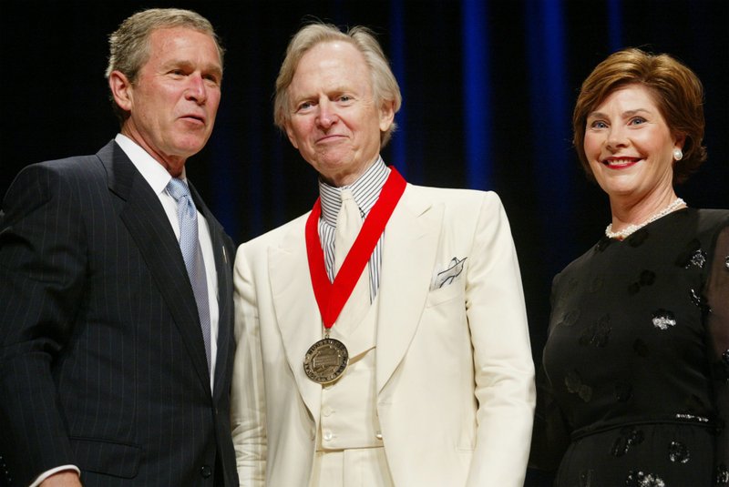 In this April 22, 2002 file photo, President Bush, left, poses with author Tom Wolfe, center, and first lady Laura Bush during the National Endowment for the Arts National Medal Awards ceremony at Constitution Hall in Washington . Wolfe was a recipient of the National Humanities Medal. Wolfe died at a New York City hospital. He was 88. Additional details were not immediately available. (AP Photo/Pablo Martinez Monsivais, File)