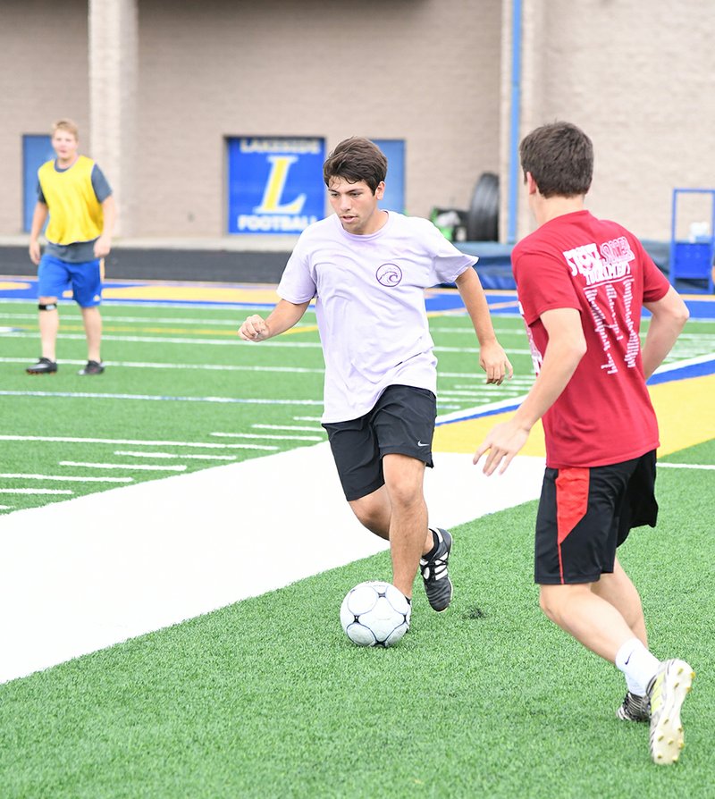 Rebekah Hedges/The Sentinel-Record LONG SHOT: Lakeside midfielder Luke Long takes the ball down the sideline during practice Tuesday at Austin Stadium. Long will move from the wing to the central midfield with the loss of Russell Gartner for Saturday's Class 5A state soccer final in Fayetteville. Gartner picked up a red card in the semifinal, so he will not be allowed to play but will join his team on the sidelines.