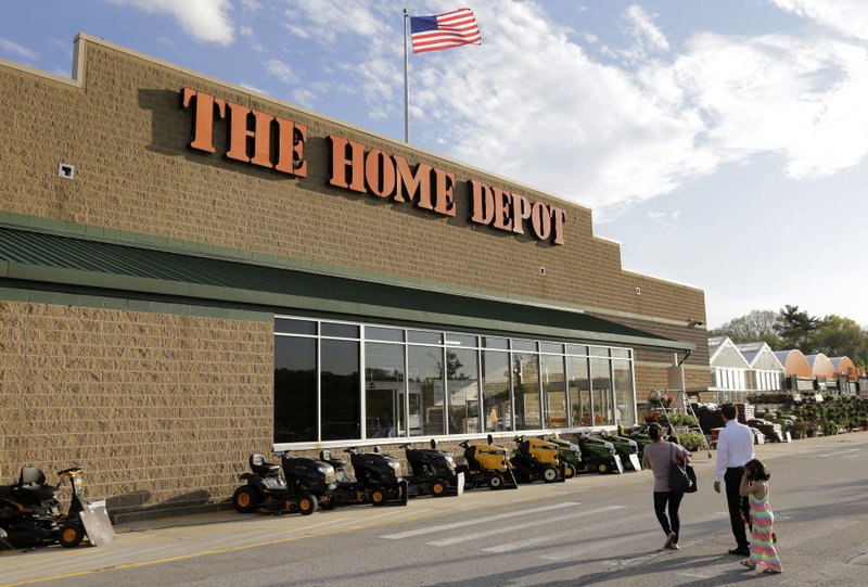 FILE - In this May 18, 2016, file photo, people approach an entrance to a Home Depot store in Bellingham, Mass. (AP Photo/Steven Senne, File)