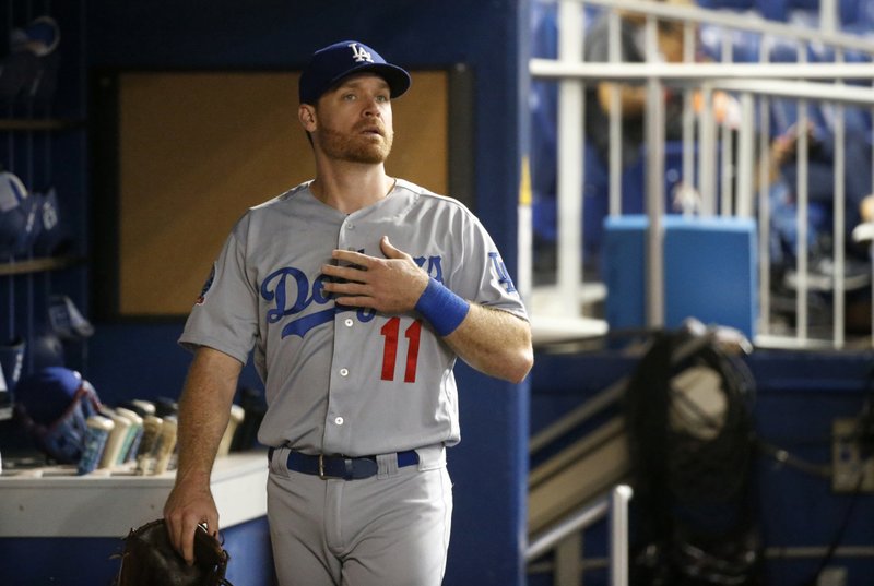 Los Angeles Dodgers' Logan Forsythe looks out of the dugout before the team's game against the Miami Marlins, Tuesday, May 15, 2018, in Miami. The slumping Dodgers have activated third baseman Justin Turner and second baseman Forsythe from the 10-day disabled list, and both are in the lineup for their game at Miami. (AP Photo/Wilfredo Lee)