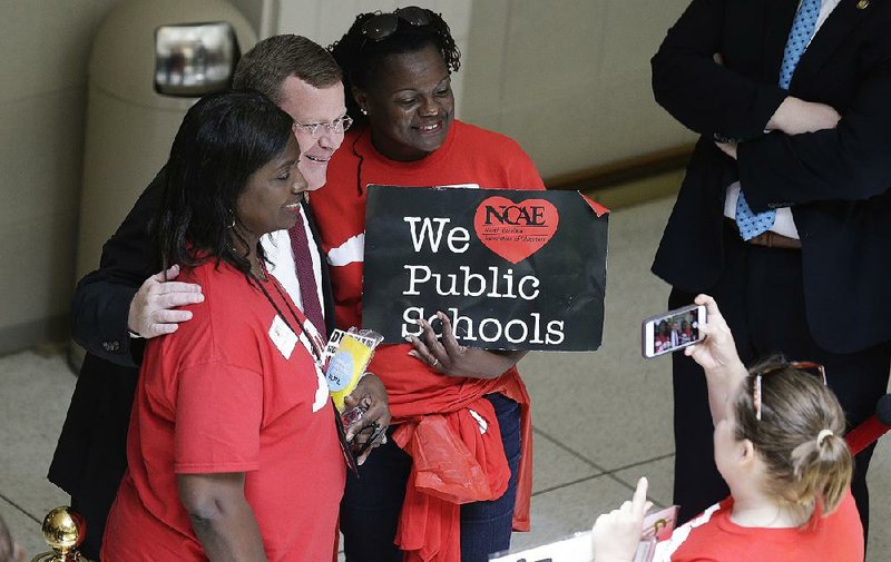 Tim Moore, speaker of the North Carolina House of Representatives, poses with teachers Wednesday during a teachers rally at the Capitol in Raleigh.  