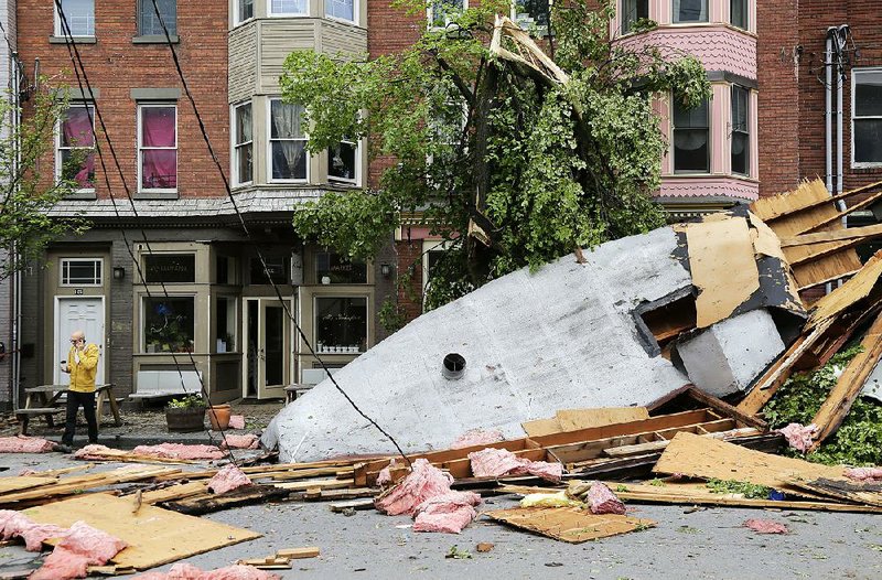 Debris litters a street Wednesday in Newburgh, N.Y., after Tuesday’s storms. 