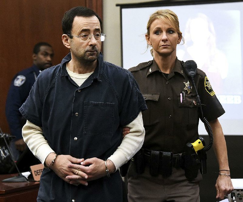 In this file photo Larry Nassar is escorted into the courtroom, Thursday, Jan. 18, 2018, in Lansing, Mich. 